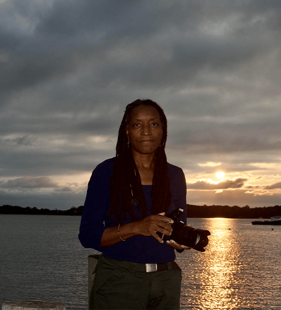 A black woman holding a camera