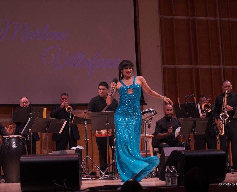 A woman in a blue dress during her performance